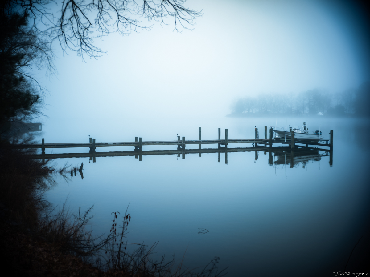 Fog obscuring a dock and boat lift in Plators Cove in Easton Maryland.
